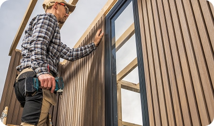 construction-worker-building-modern-composite-wood-made-shed construction worker building modern composite wood made shed